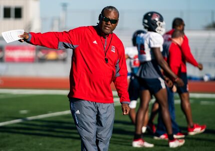 Head Coach George Teague gives instructions as the John Paul II High School football team...