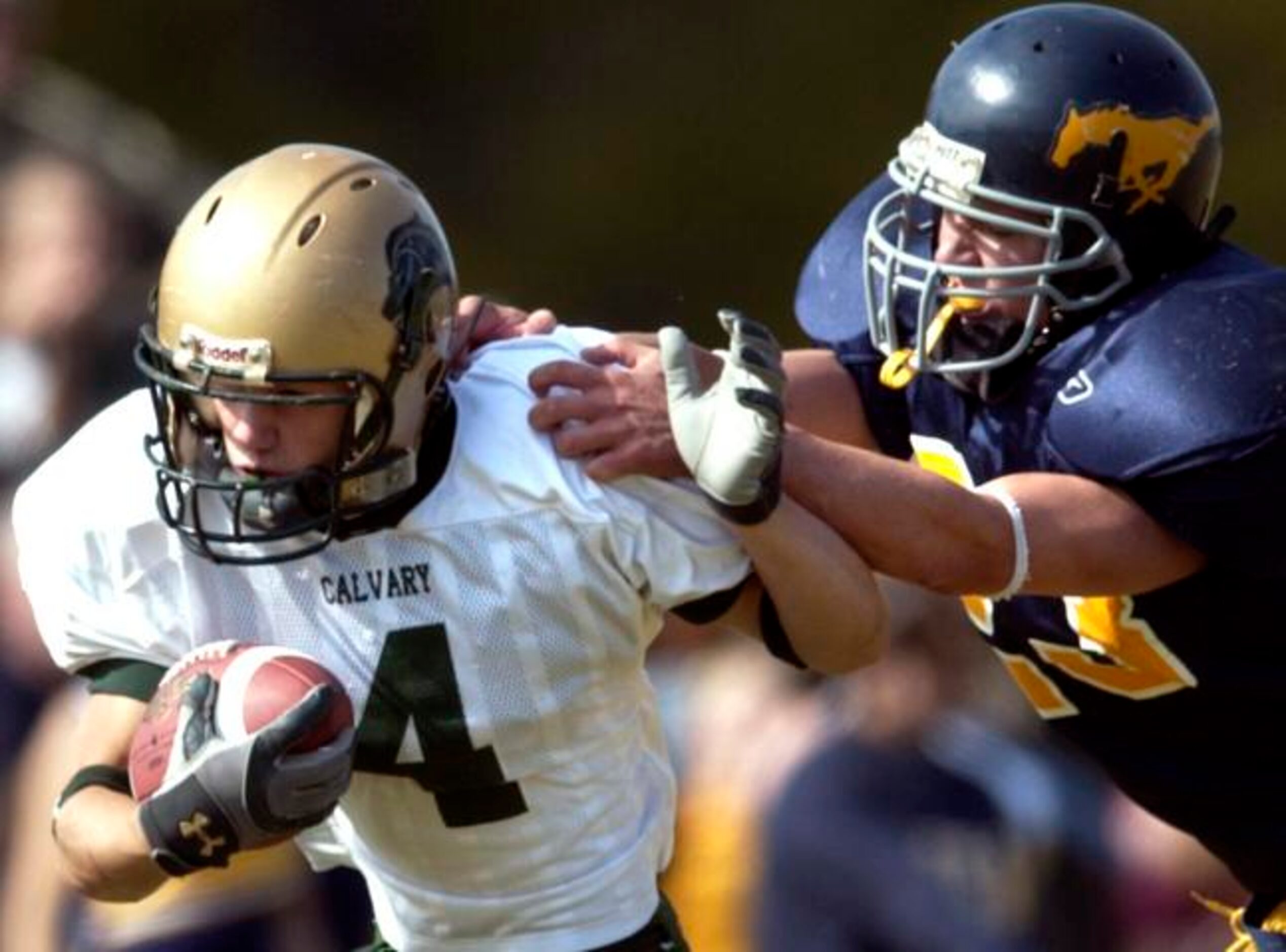 McKinney Christian's Andy Tucker (right) tries to tackle Denton Calvary's John Hudspeth.