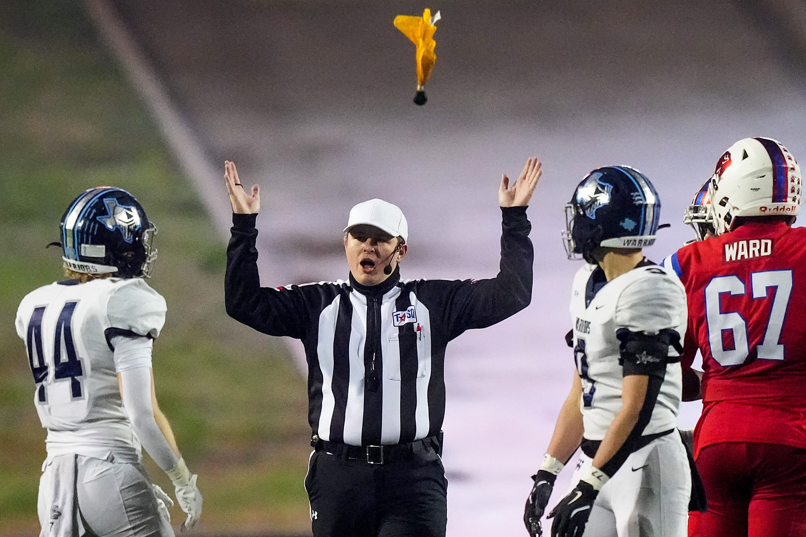 A flag flies as Argyle Liberty Christian linebacker Jett Haire (44) is called for a personal...