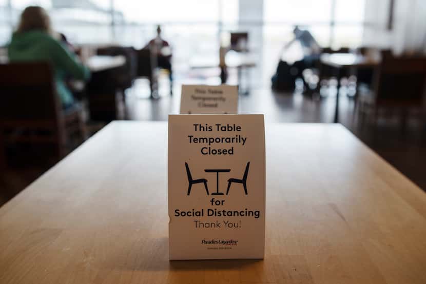 Social distancing signage at the Hickory restaurant inside Terminal B at DFW International...