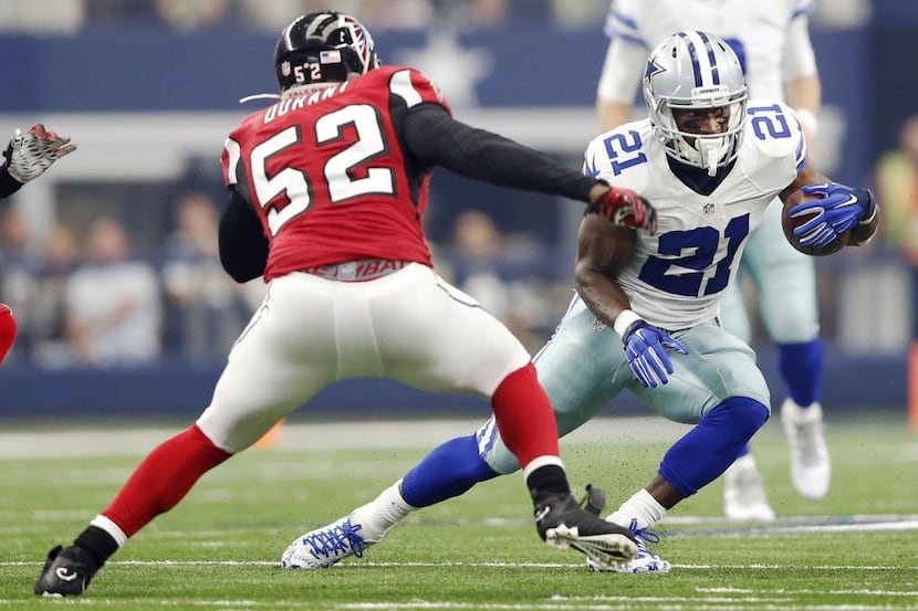 Dallas Cowboys running back Joseph Randle (21) attempts to evade Atlanta Falcons linebacker...