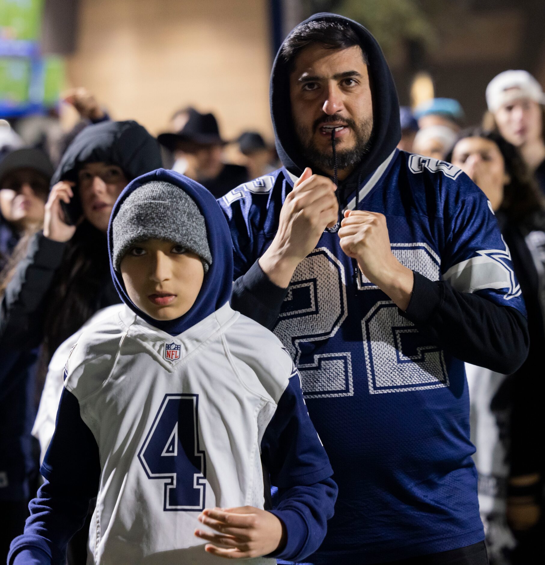 Justin Armendariz and son Maddox Armendariz, 11, watch as the Cowboys attempt to catch up to...