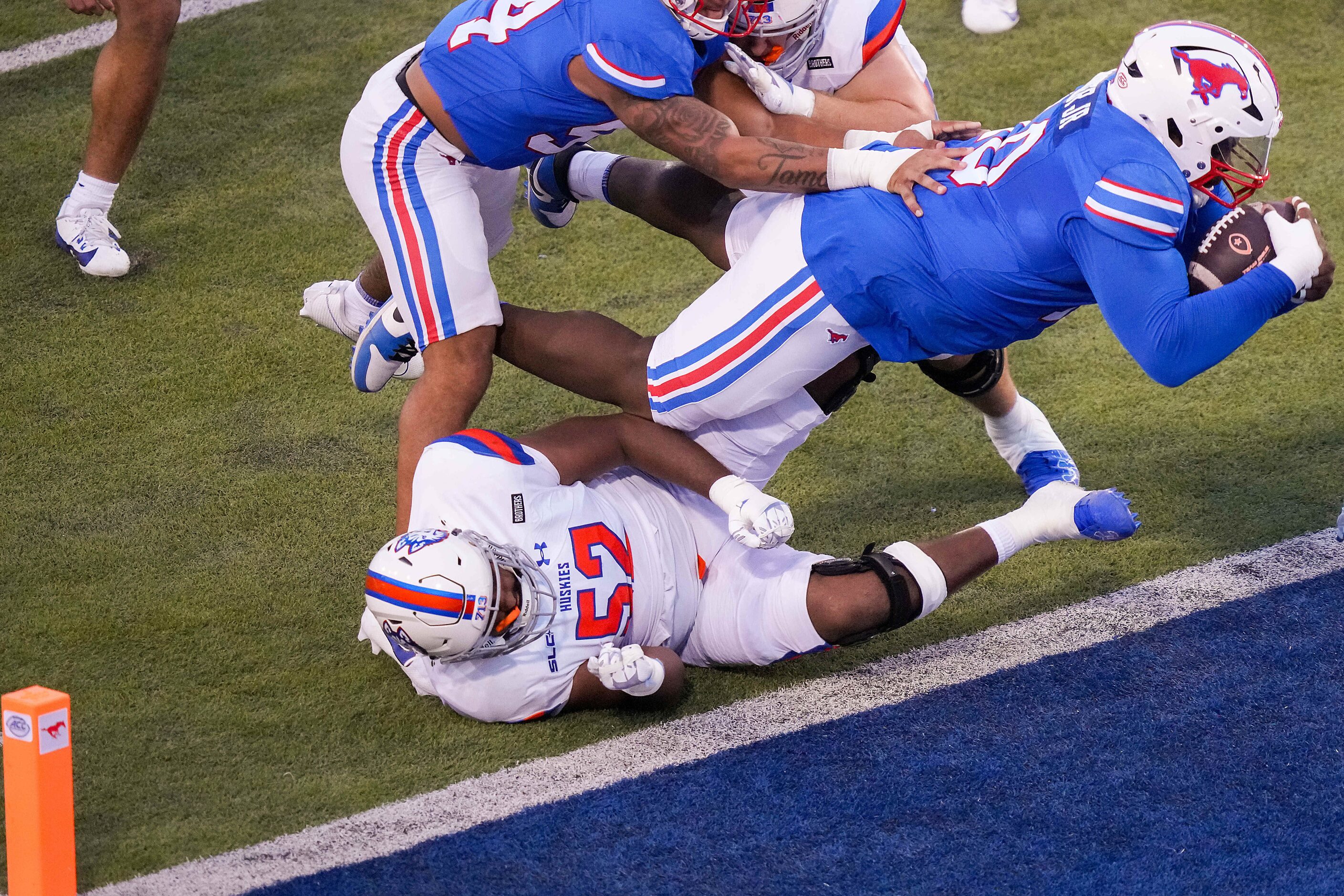 SMU defensive tackle Anthony Booker Jr. (10) dives over Houston Christian offensive lineman...