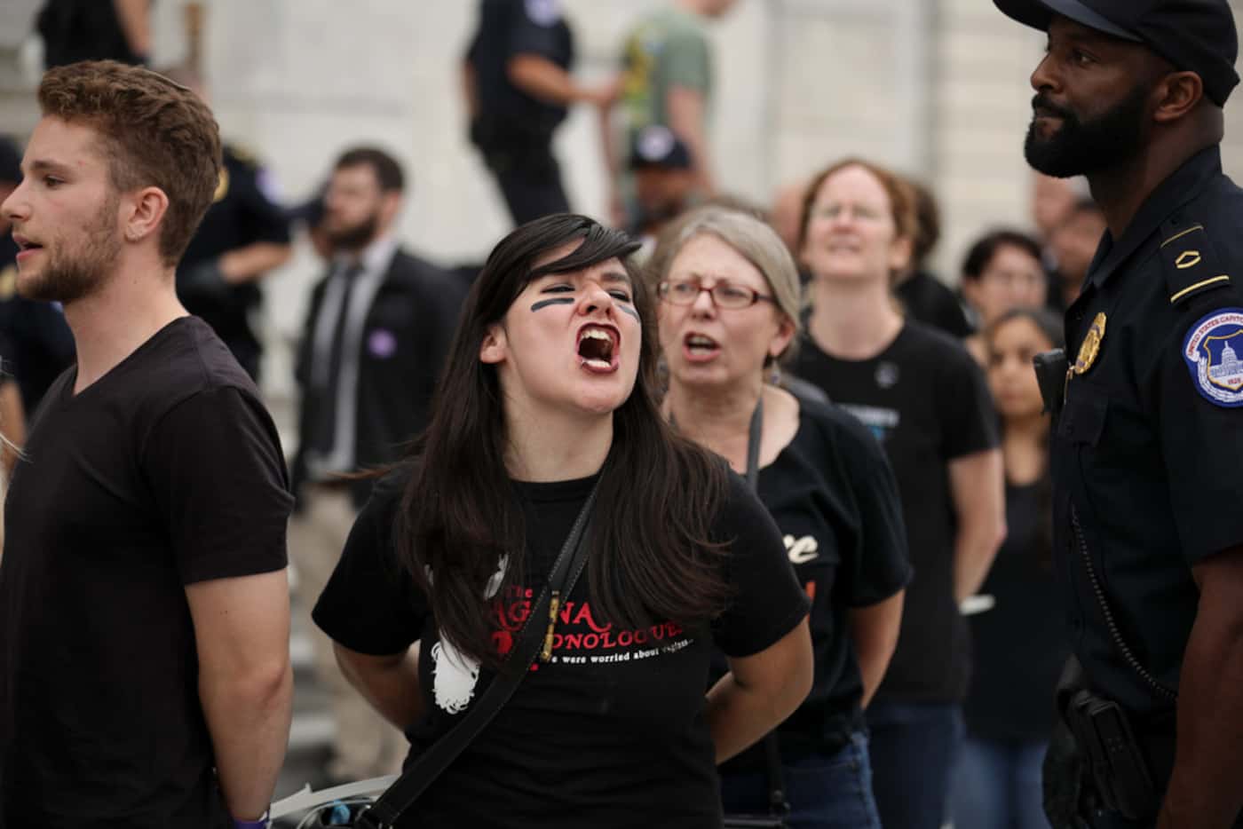 Protesters shout, sing and chant after being arrested by U.S. Capitol Police for...