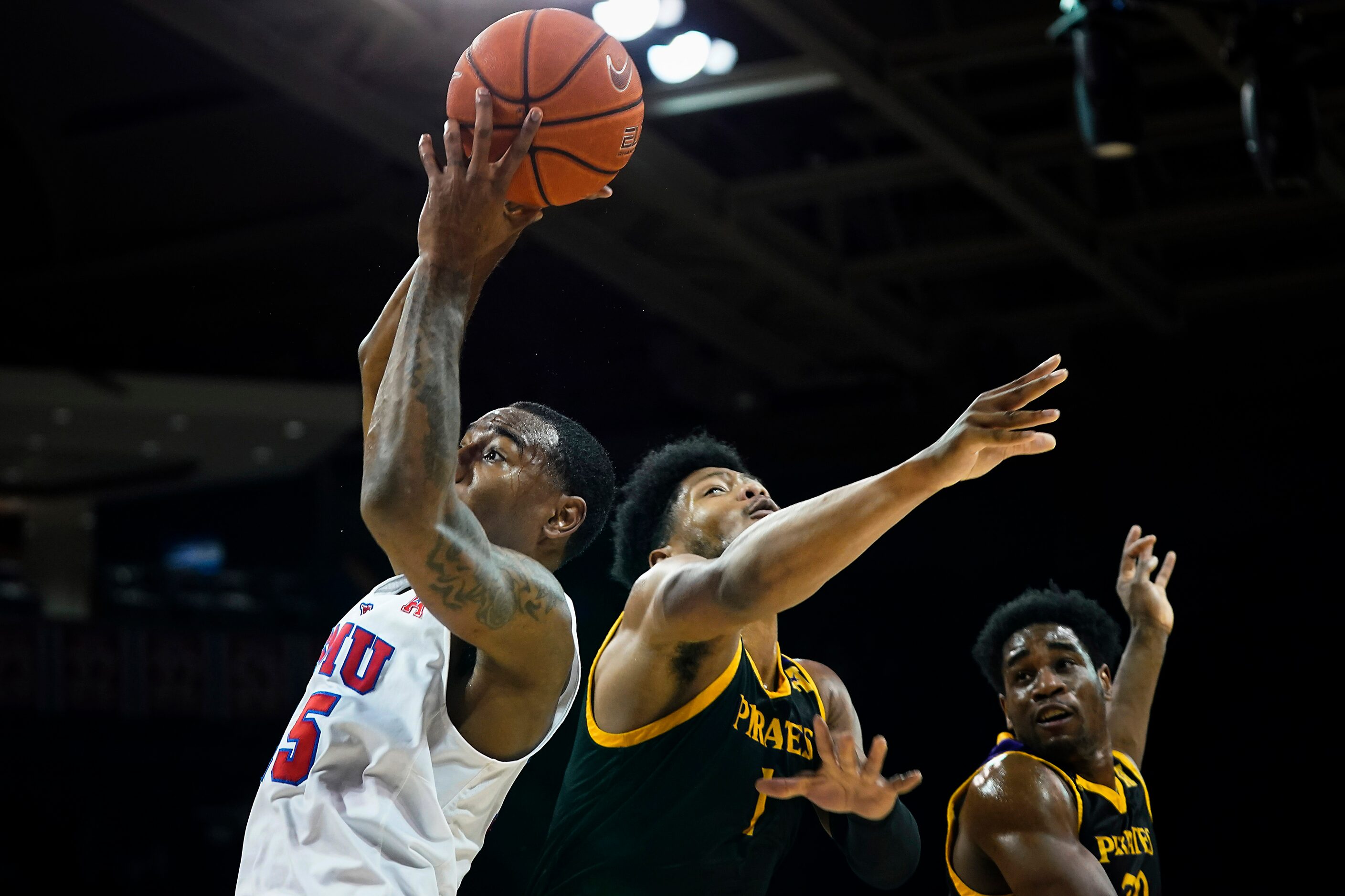 SMU forward Isiaha Mike (15) pulls down a rebound in front of East Carolina forward Jayden...