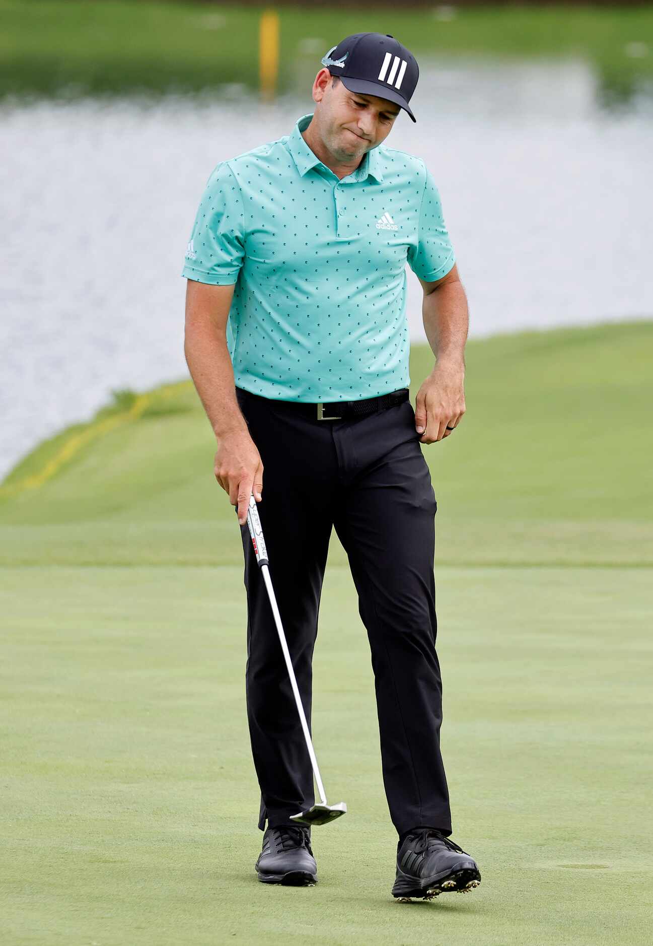 Professional golfer Sergio Garcia reacts after missing his birdie putt on No. 16 during...
