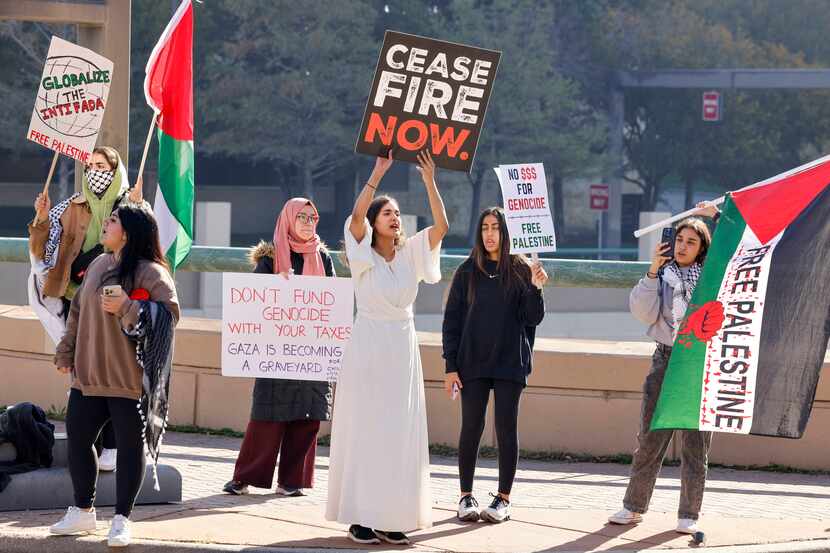 Protesters chant during a demonstration to boycott Black Friday outside NorthPark Center in...