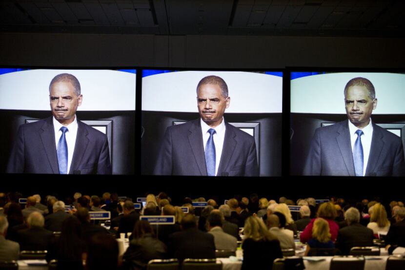 Attorney General Eric Holder is projected on a screen while speaking at the American Bar...