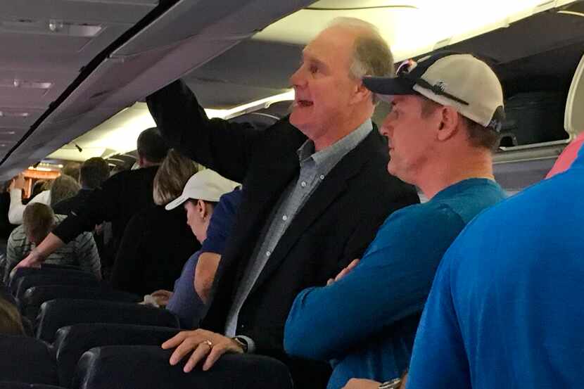 Southwest Airlines CEO Gary Kelly retrieves his bags from the overhead compartment after...