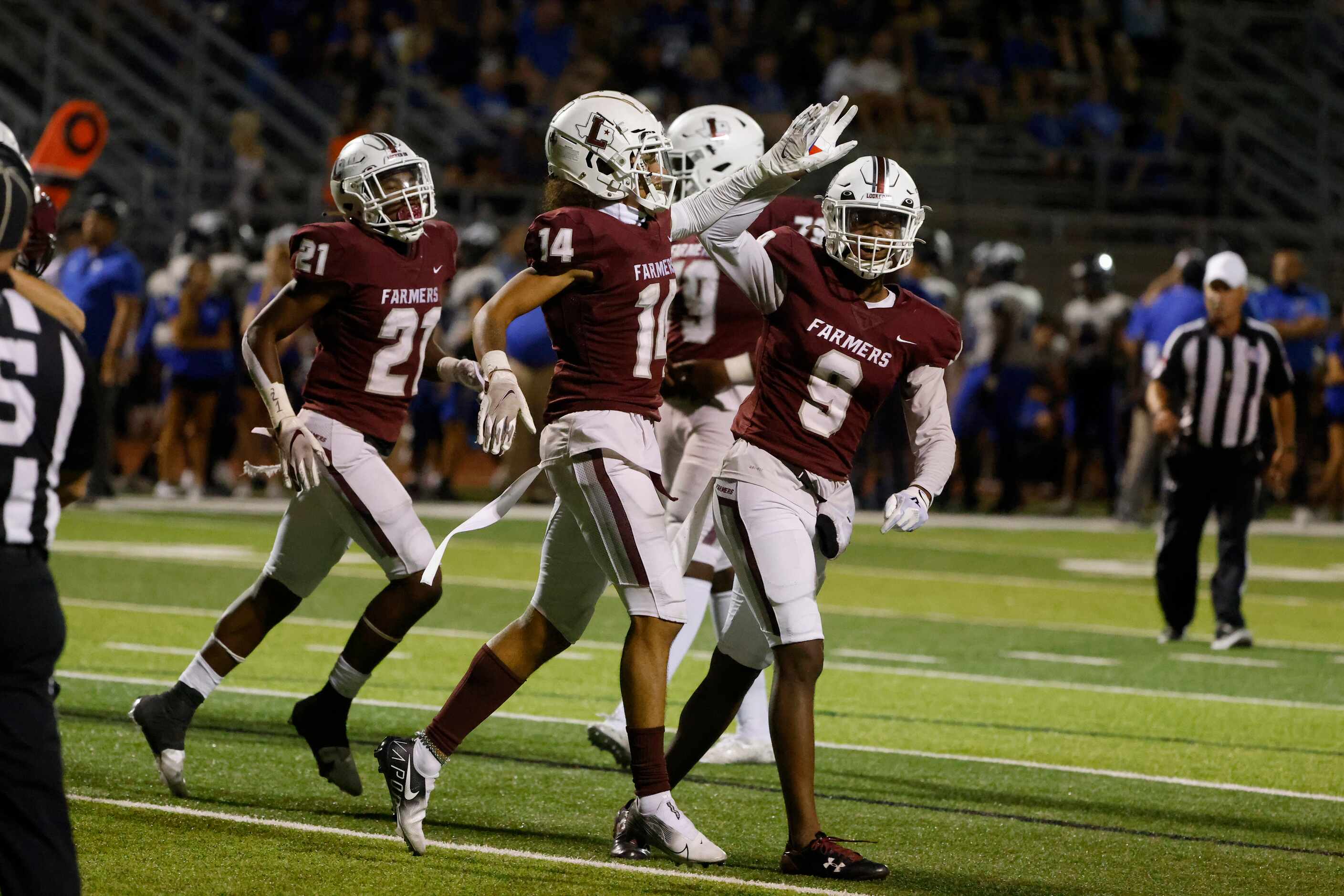 Lewisville wide receiver Kye Stone (14) gets congratulated by Armani Winfield after scored...