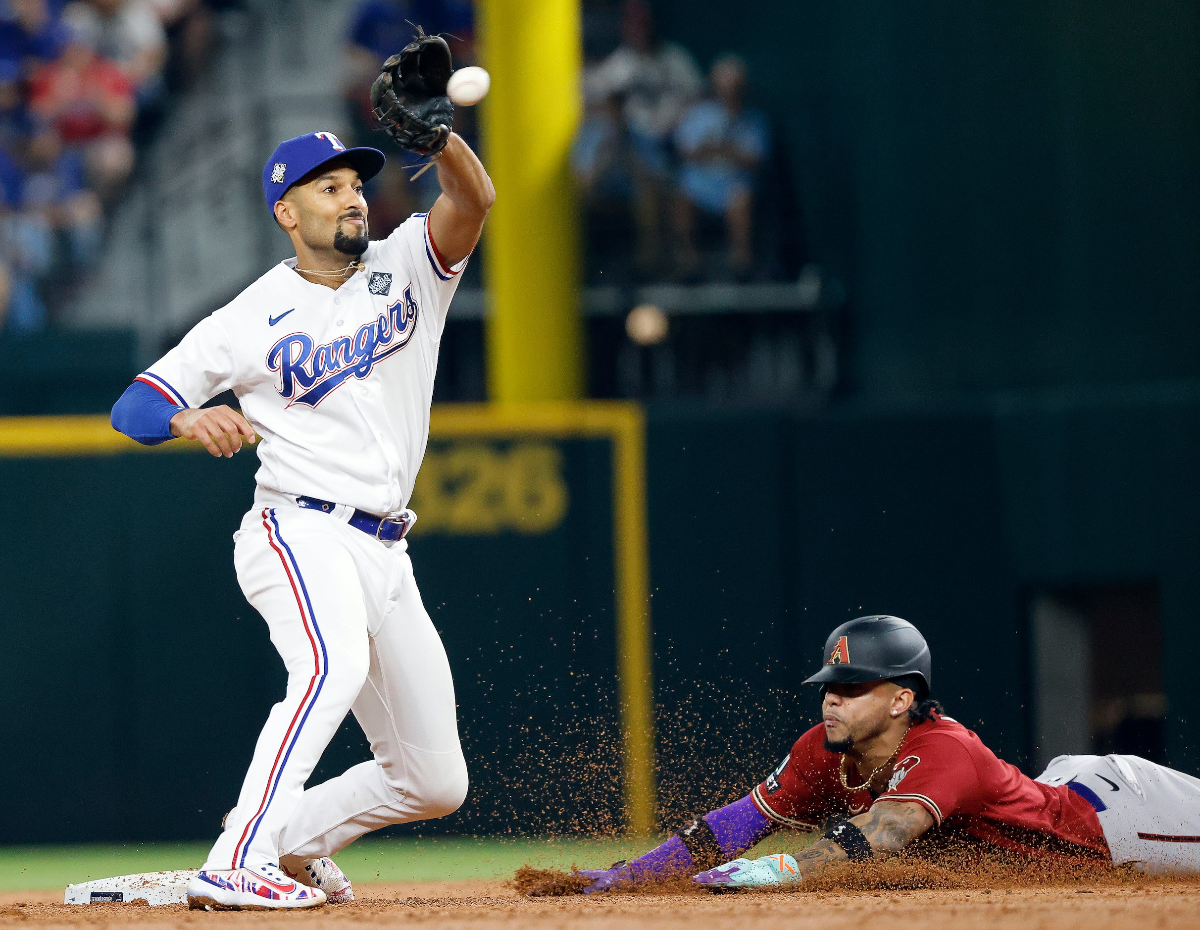 Texas Rangers second baseman Marcus Semien's tag is late as Arizona Diamondbacks' Ketel...