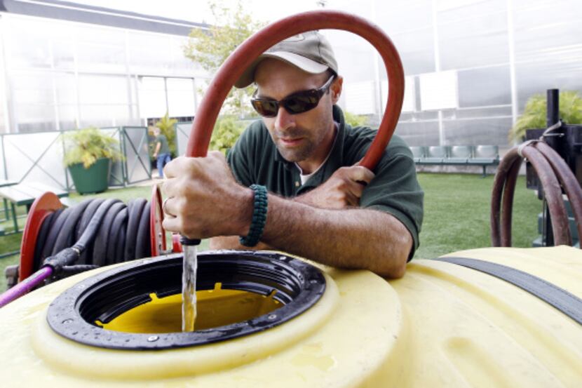 Drew Demler filled a water wagon at the fair recently. Well water found 40 feet beneath the...