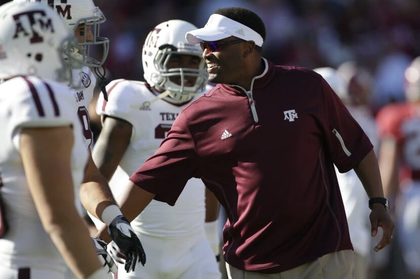 Texas A&M coach Kevin Sumlin talks with his players prior to the start of an NCAA college...