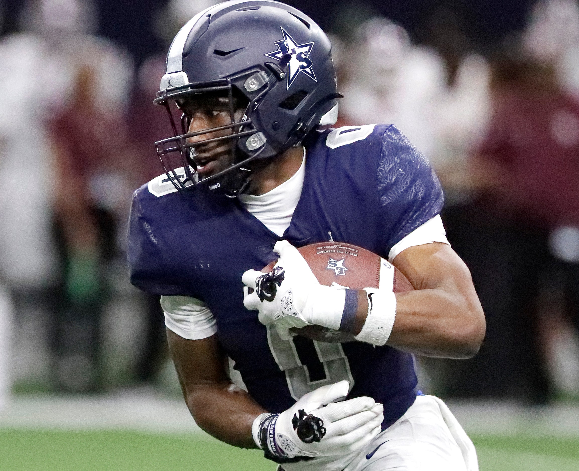 Lone Star High School running back Davian Groce (0) looks for room to run during the first...