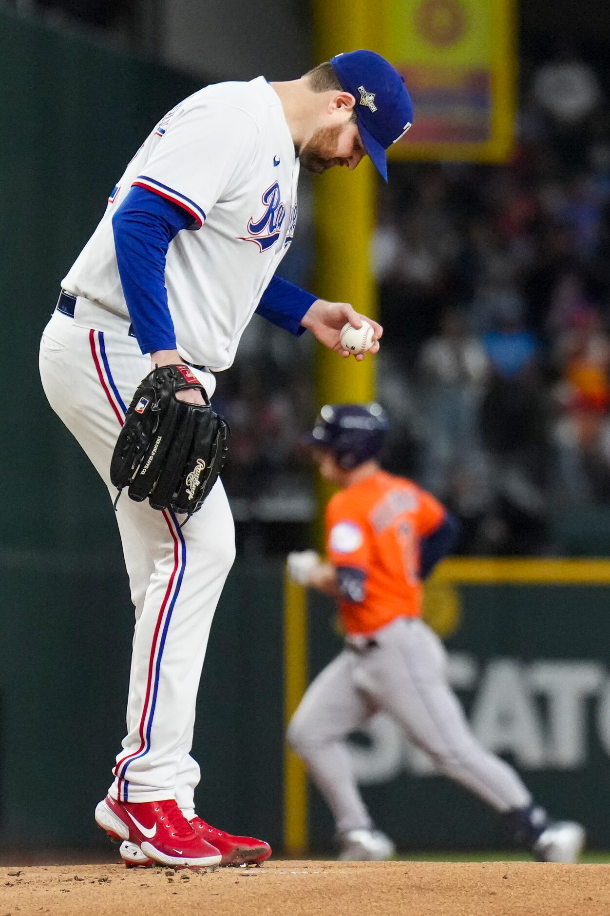 Texas Rangers starting pitcher Jordan Montgomery kicks at the mound as Houston Astros third...