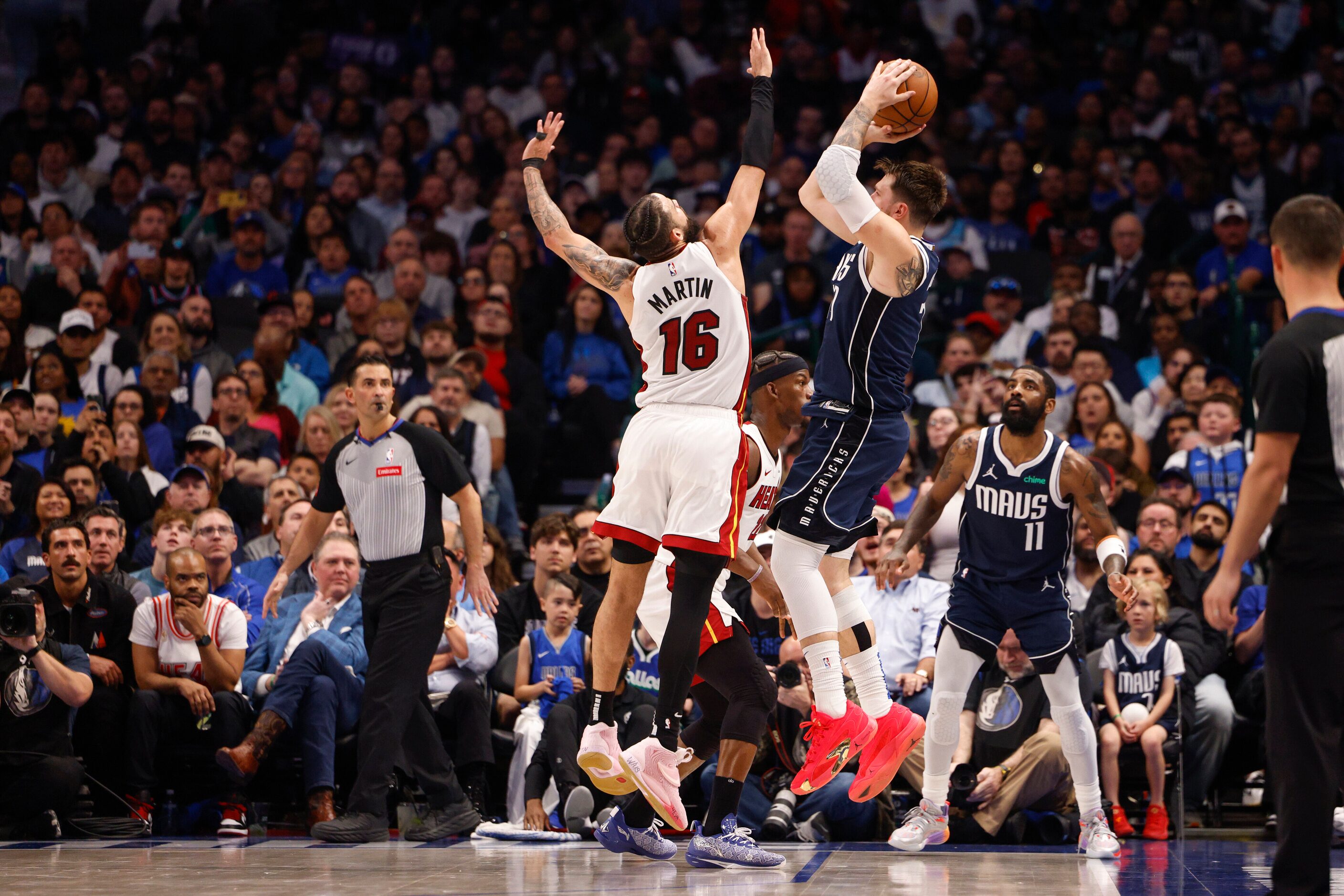 Dallas Mavericks guard Luka Doncic (77) shoots over Miami Heat forward Caleb Martin (16)...