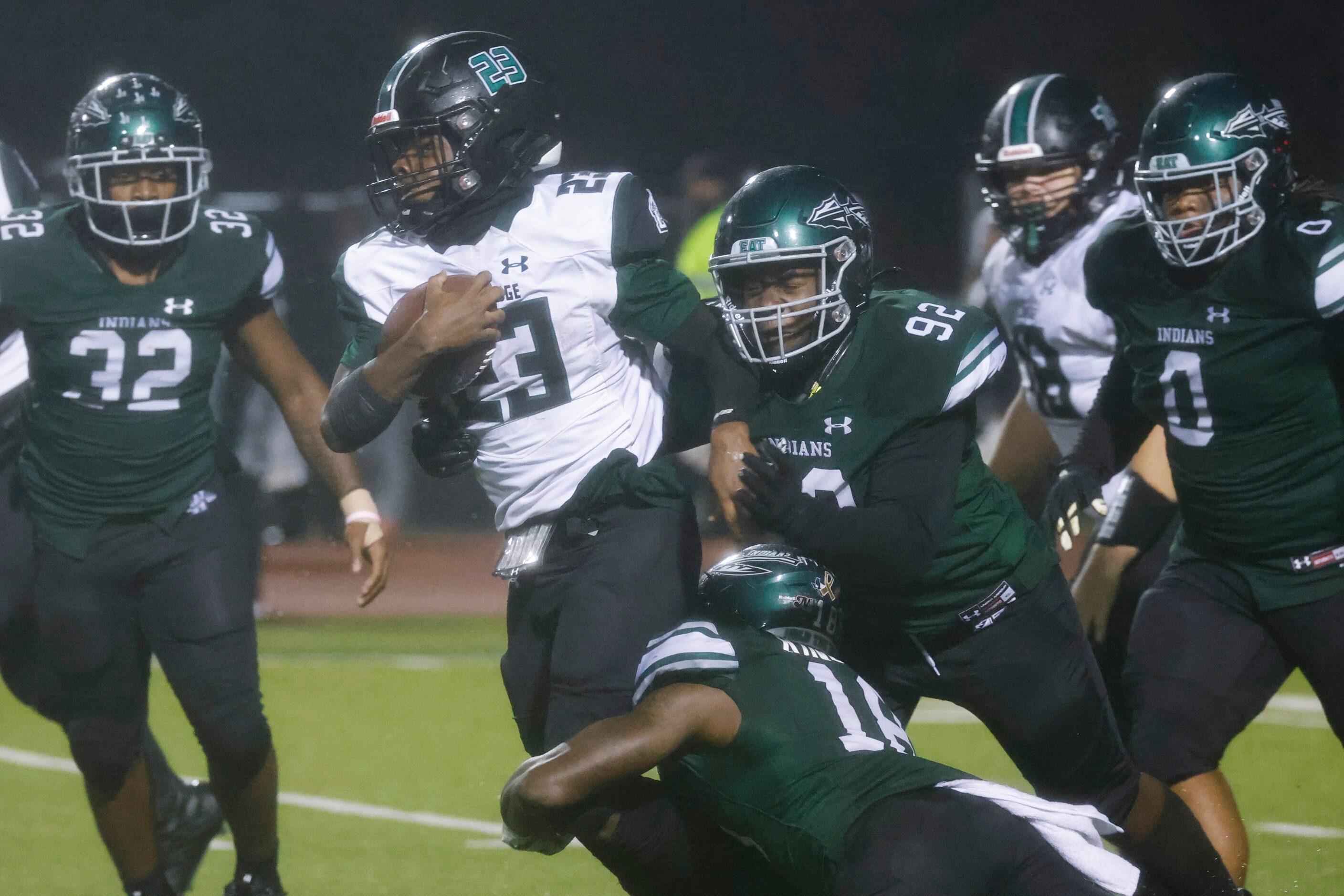 Lakeridge’s Raycine Guillory (23) gets tackled by Waxahachie’s Corey King Jr. (18), bottom,...