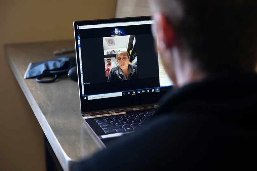 Dr. Ryan Klitgaard, right, speaks with a patient during a telemedicine visit at a MaxHealth...