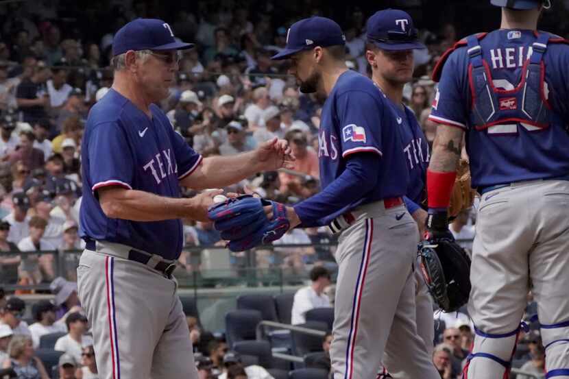 Texas Rangers manager Bruce Bochy, left, relieves pitcher Nathan Eovaldi during the sixth...