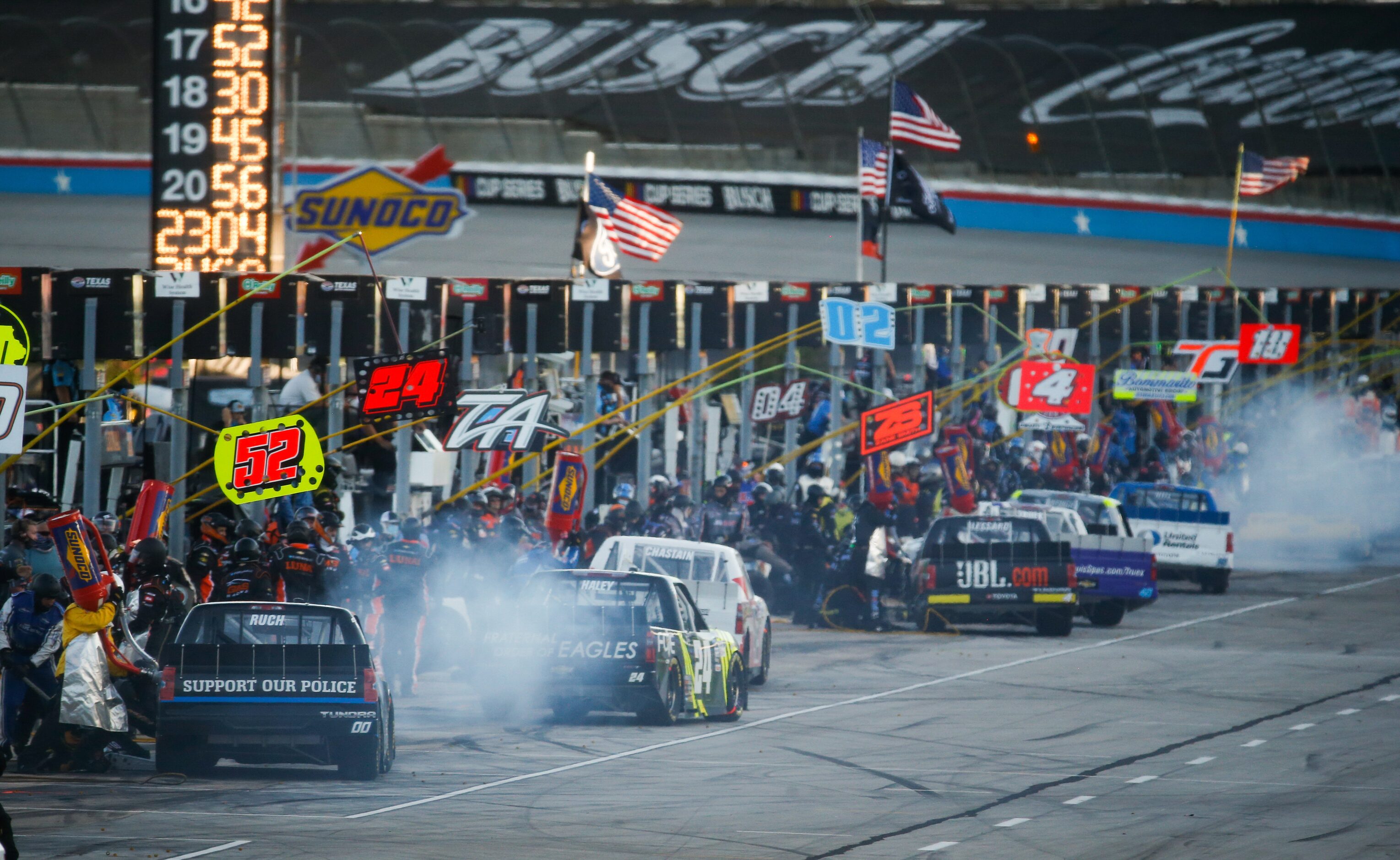 Drivers stop at pit row during the NASCAR VANKOR 350 truck series race at Texas Motor...