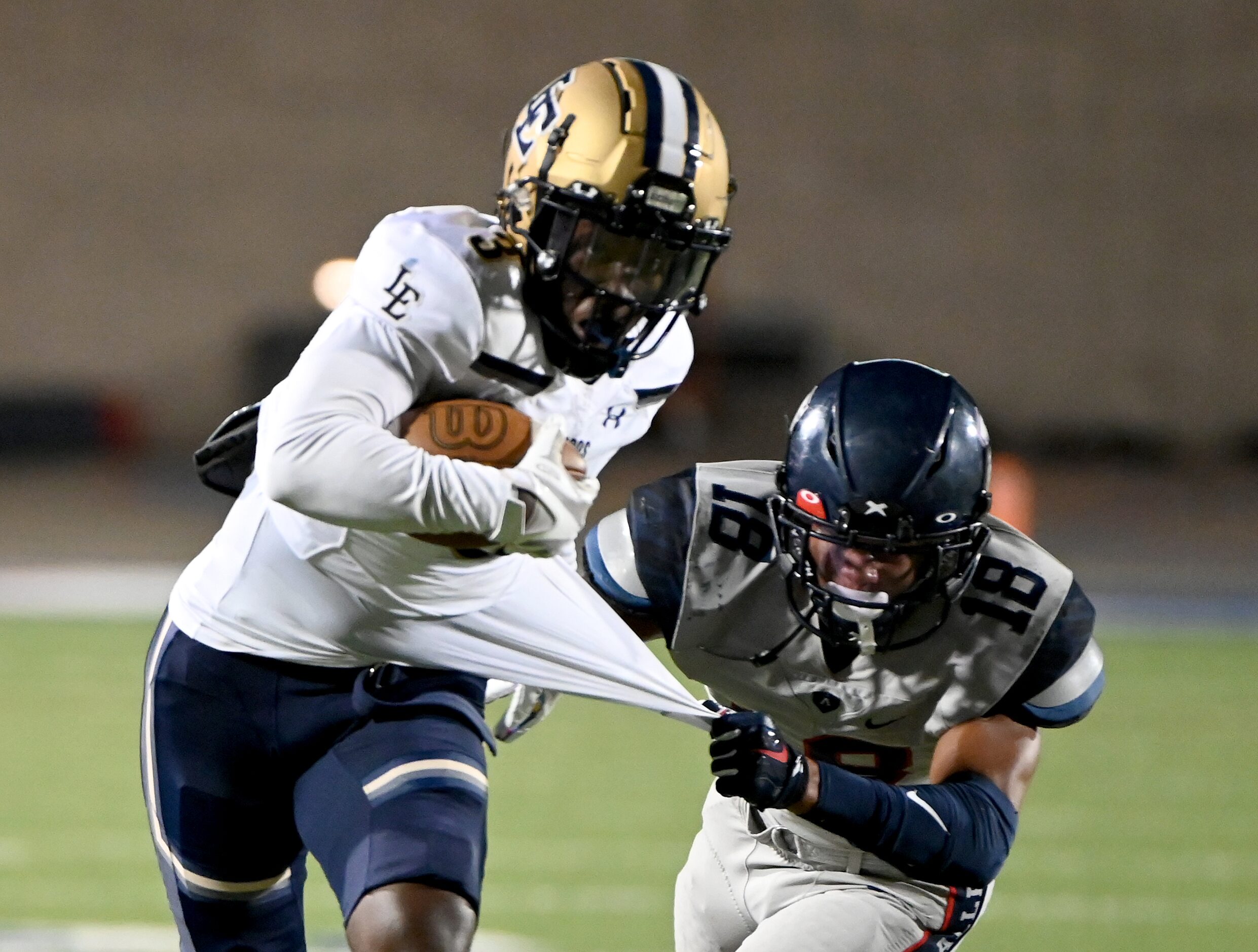 Little Elm’s Vashawn Thomas II (3) runs through a tackle attempt by Allen’s Malakai Thornton...