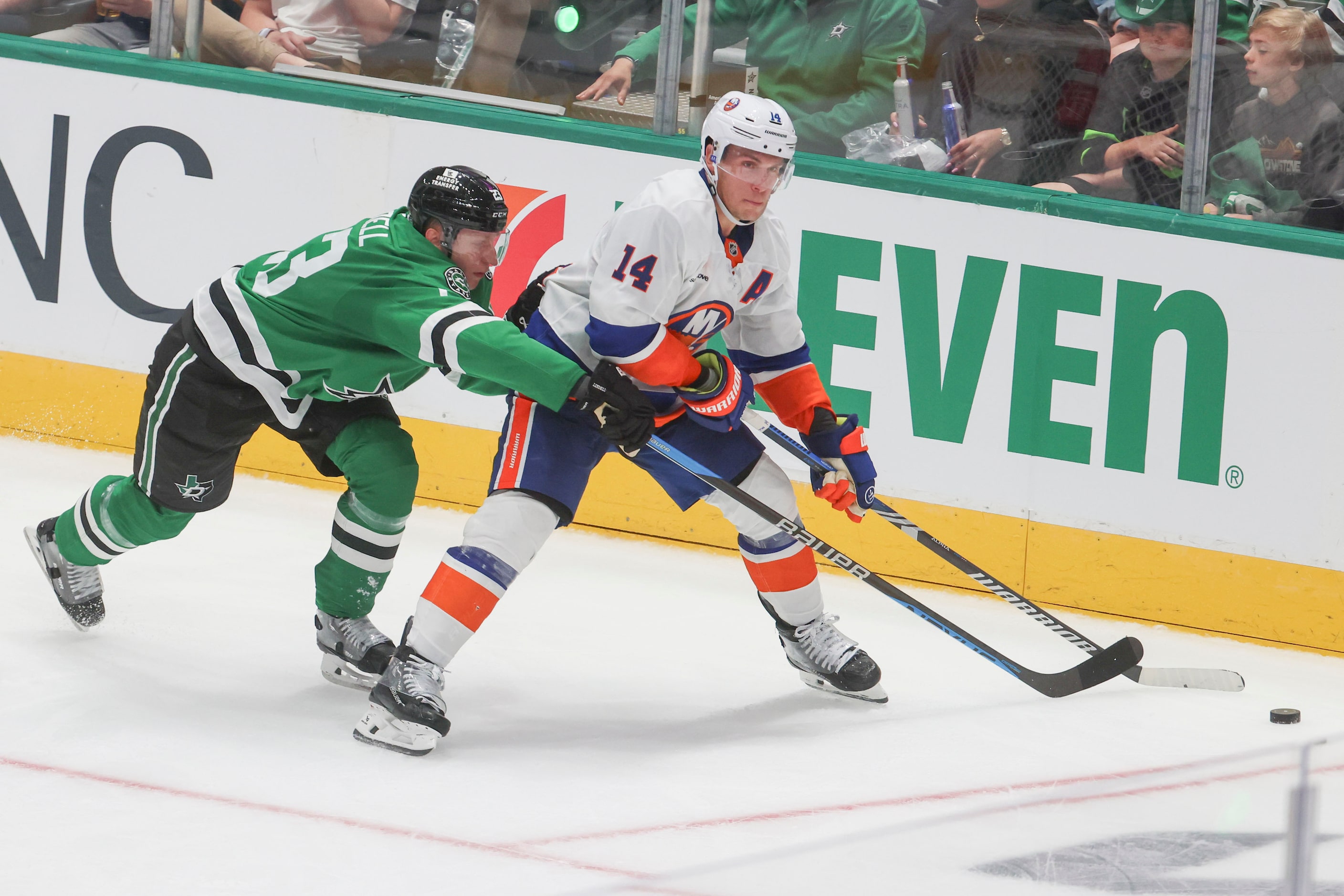 Dallas Stars defenseman Esa Lindell (left) reaches for the puck against New York Islanders...