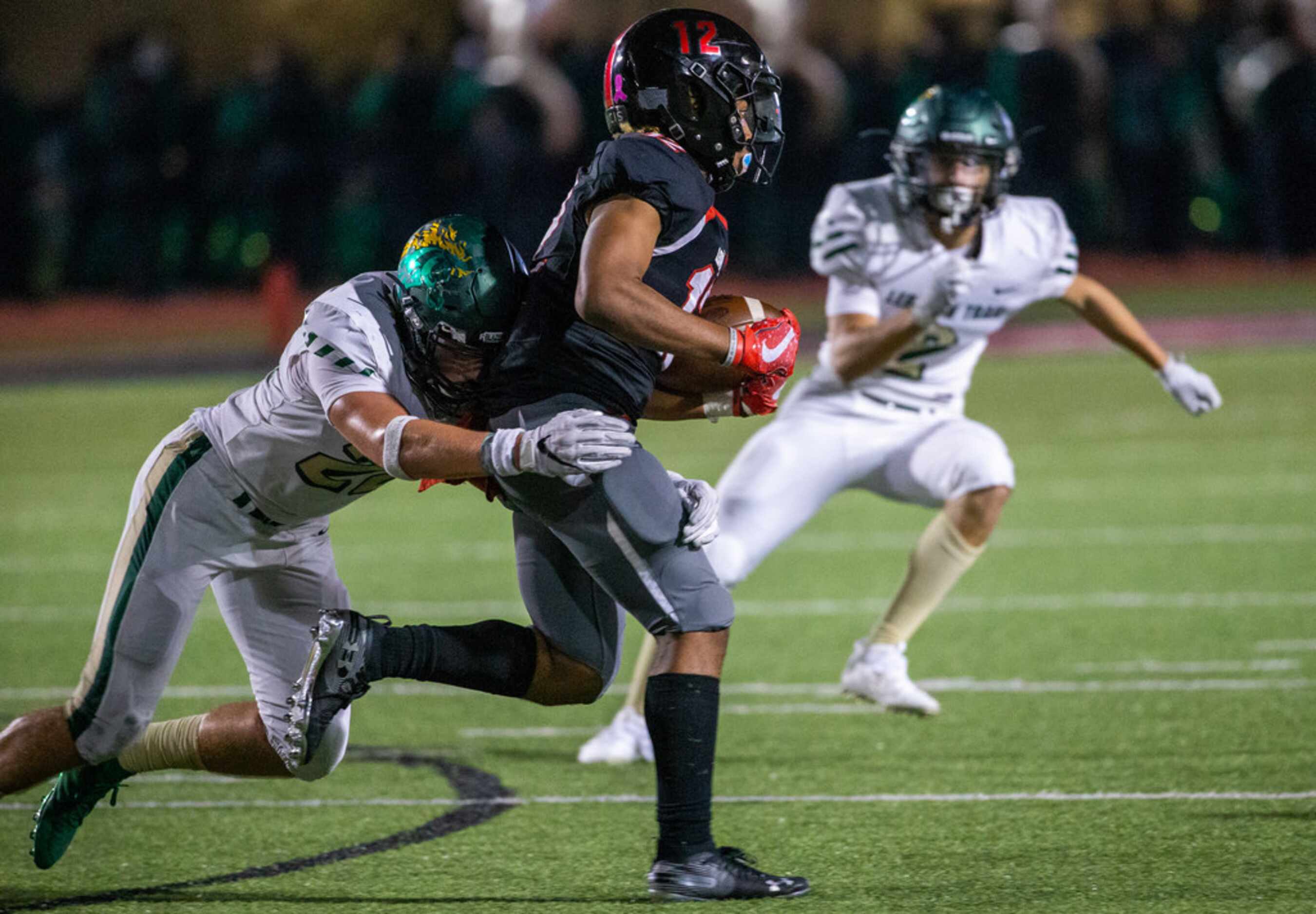 Lovejoy quarterback Noah Naldoo (12) gets tackled by Lebanon Trail line backer Roman Knautz...