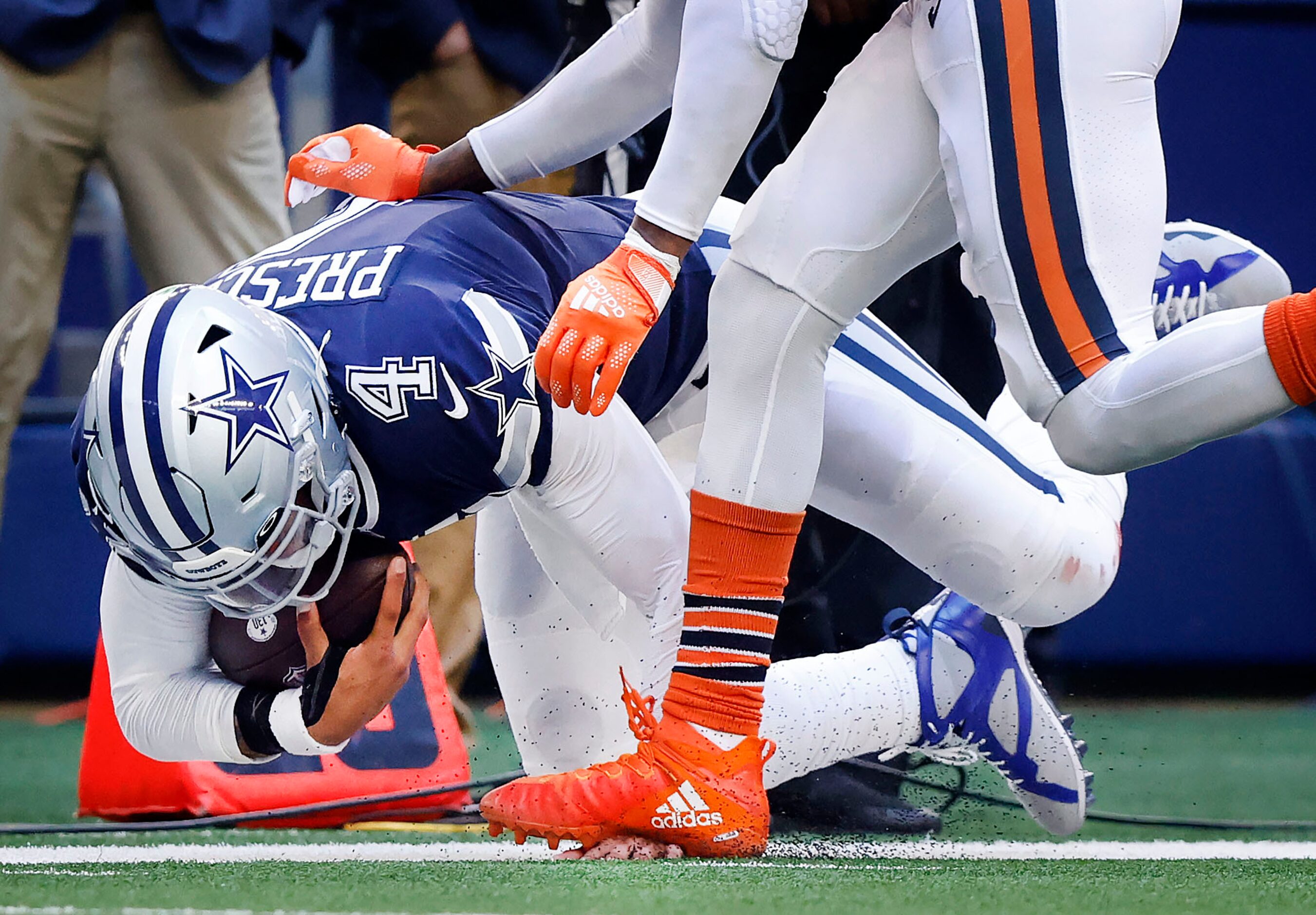 Dallas Cowboys quarterback Dak Prescott (4) has his hand stepped on by Chicago Bears safety...