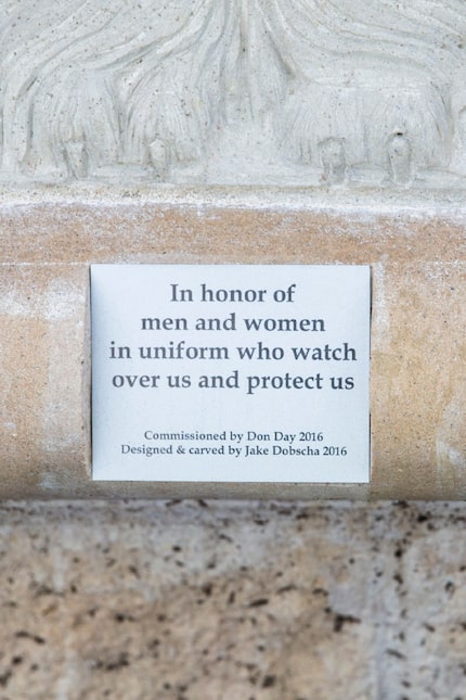 A plaque on a sculpture called "The Watchdog" by artist Jake Dobscha on Wednesday, December...