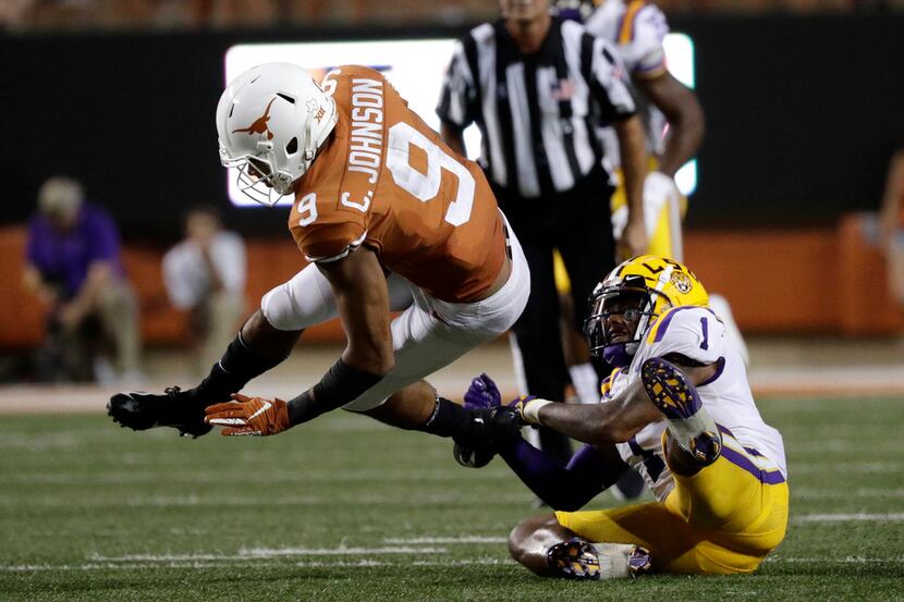 Texas wide receiver Collin Johnson (9) is tackled by LSU cornerback Kristian Fulton, right,...