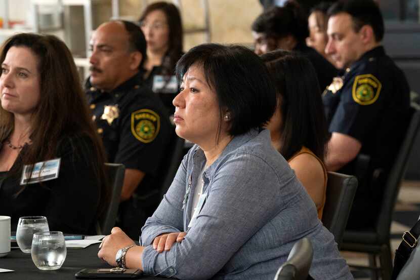 Anti-human trafficking advocate Sinmin Pak listens during a forum on hate crimes against...