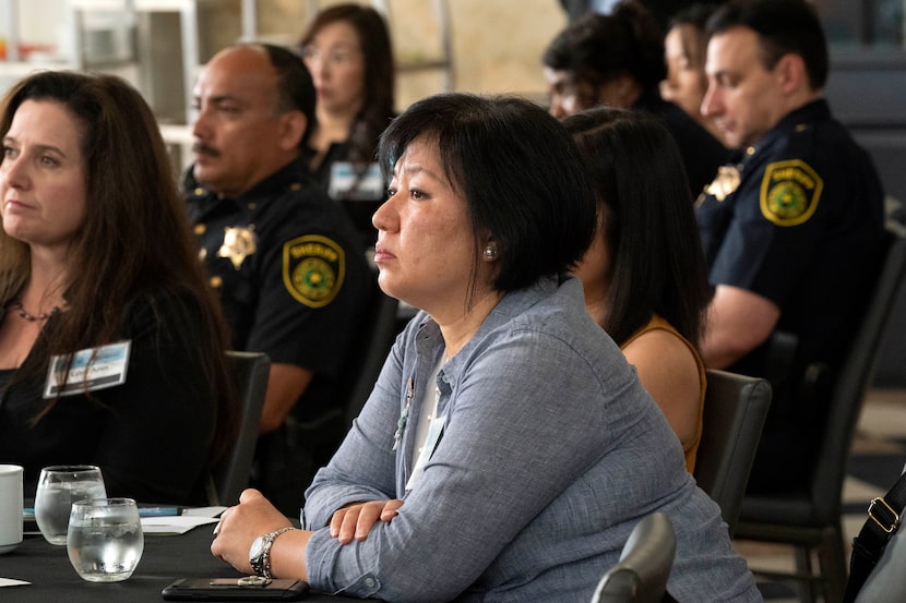 Anti-human trafficking advocate Sinmin Pak listens during a forum on hate crimes against...