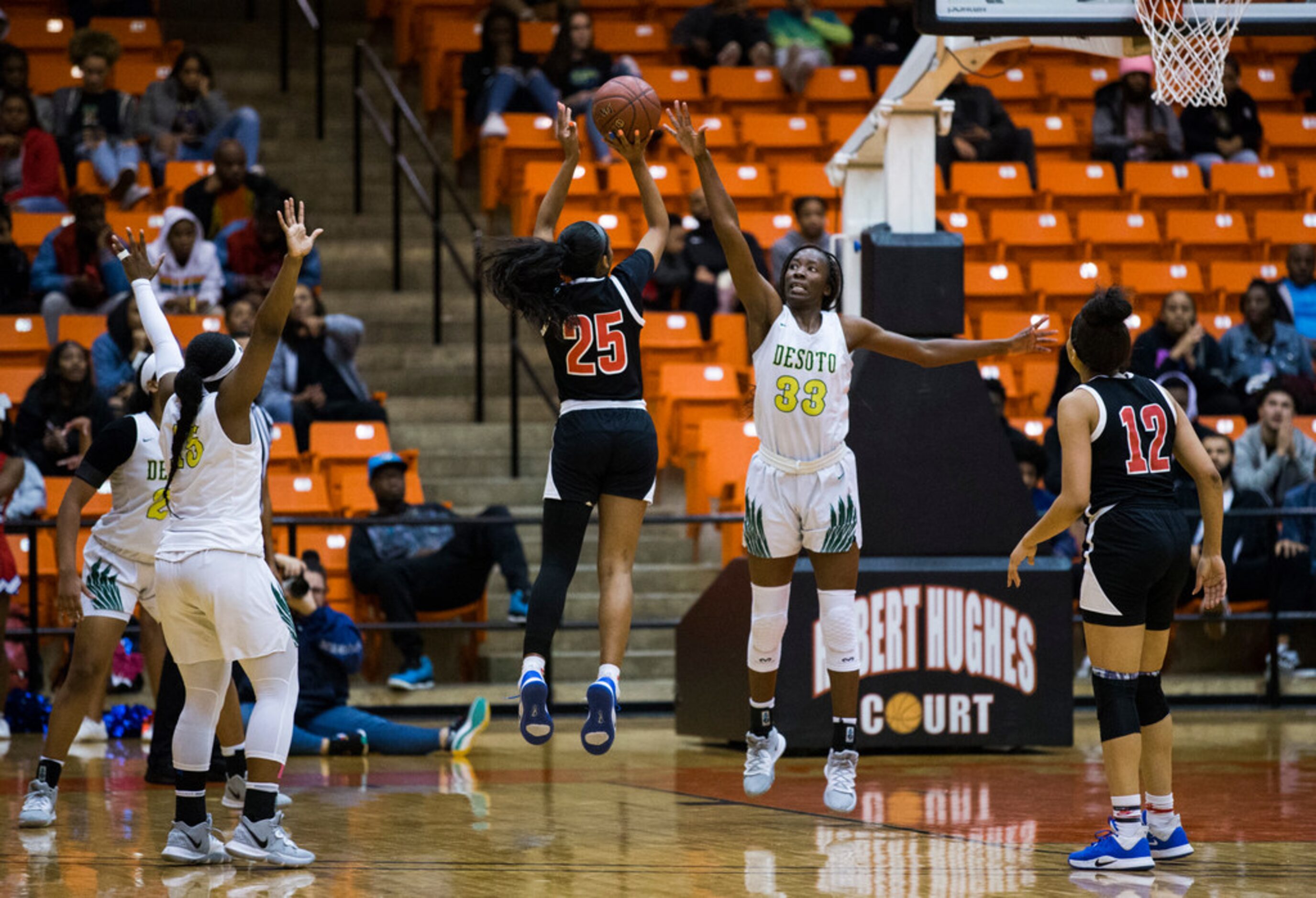 Duncanville's Deja Kelly (25) takes a shot over DeSoto's Amina Muhammad (33) during the...