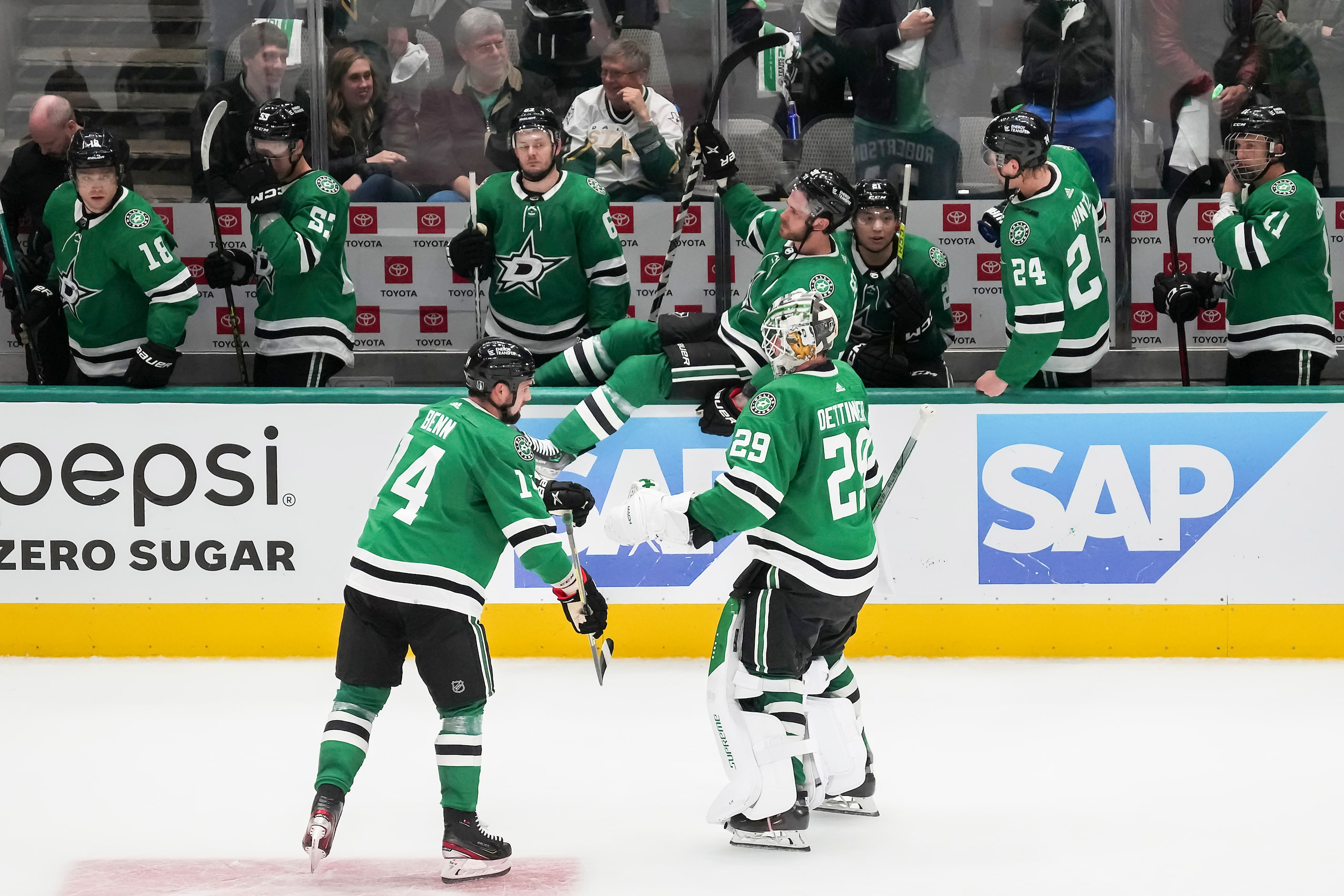 Dallas Stars goaltender Jake Oettinger (29) and left wing Jamie Benn (14) leave the ice...