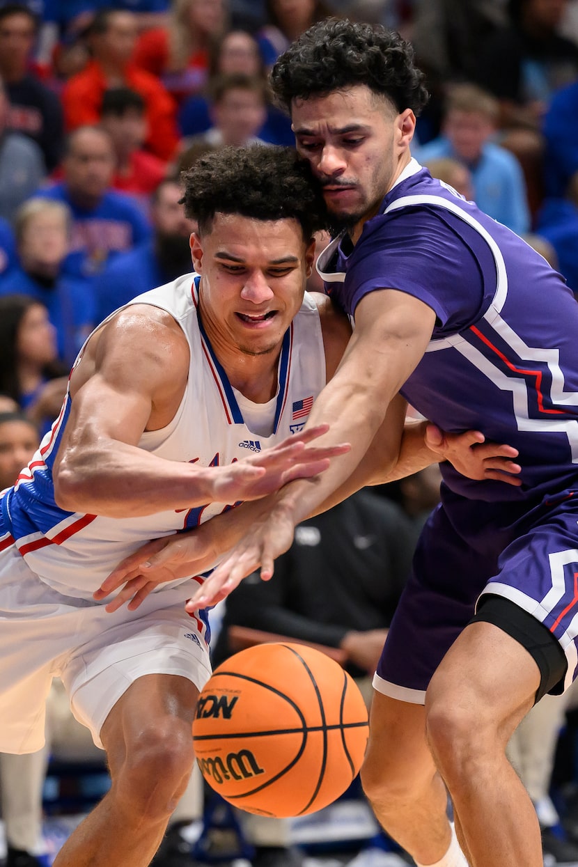 TCU guard Trevian Tennyson, right, tries to steal the ball from Kansas guard Kevin McCullar...