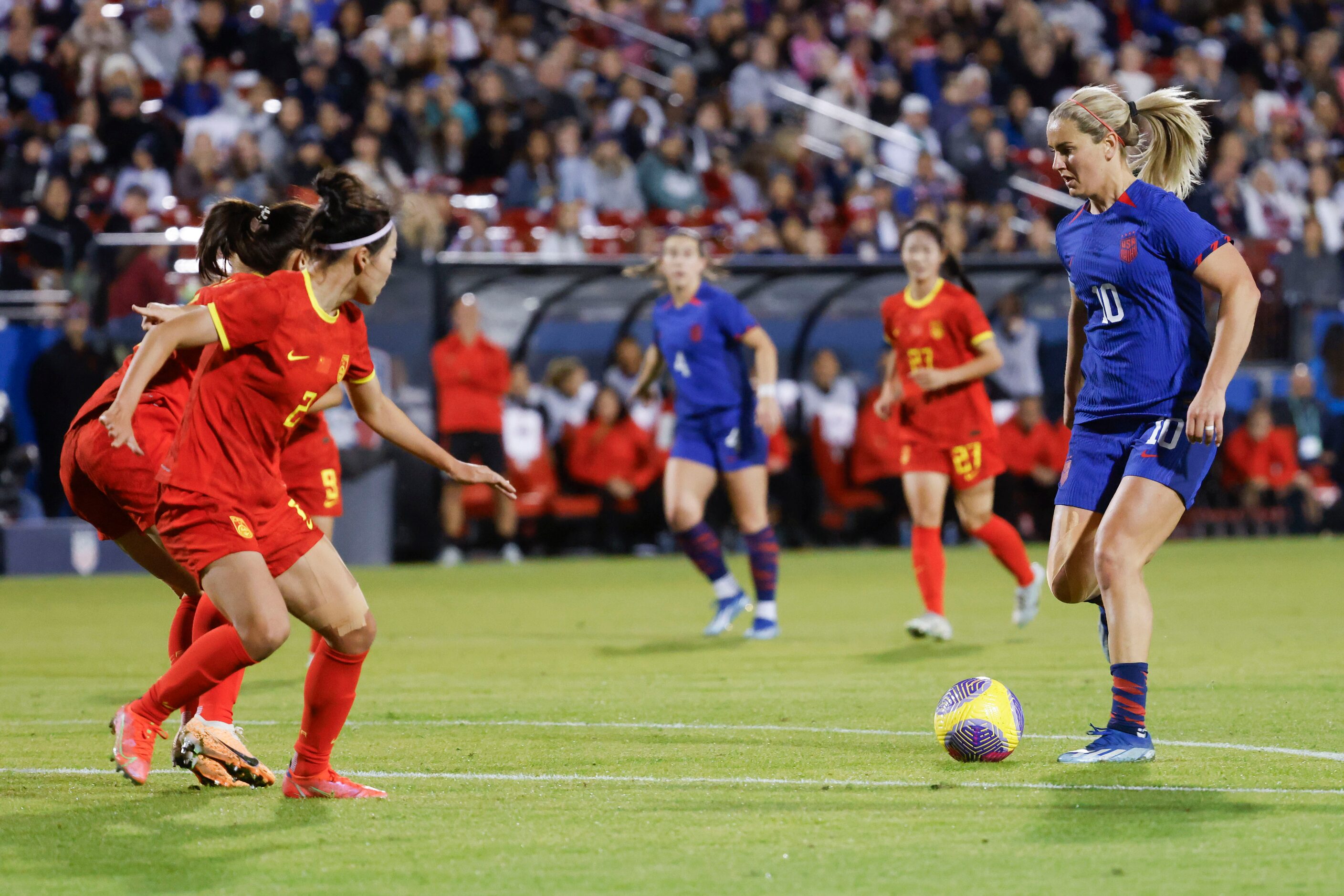 United States’ Lindsey Horan (right) looks to shoot past China’s defense during the first...