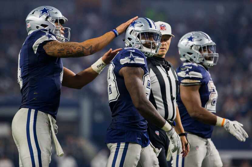 Dallas Cowboys quarterback Dak Prescott (4) celebrates a play with wide receiver Dez Bryant...