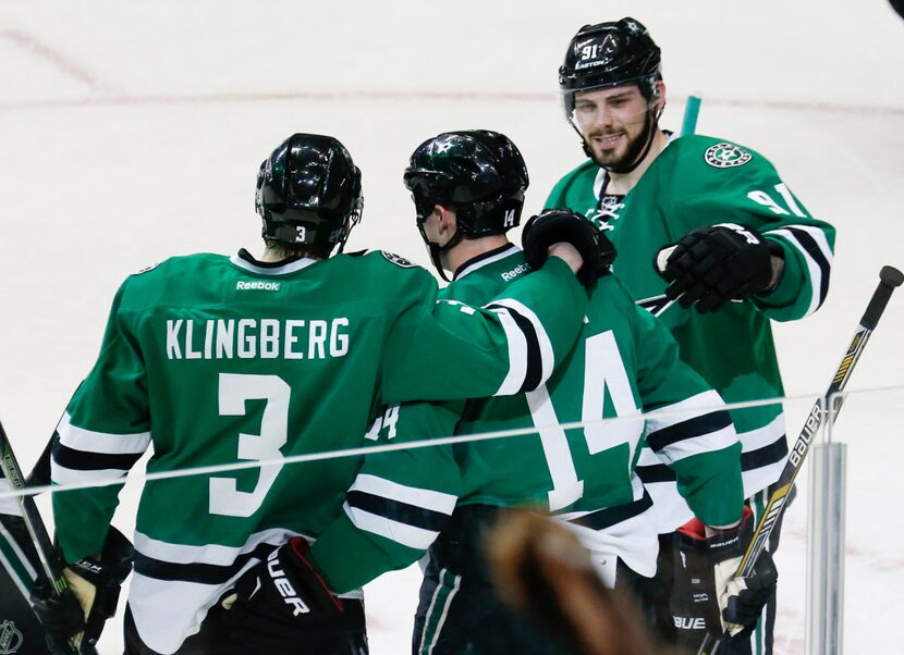 Dallas Stars teammates John Klingberg (3, left) and Tyler Seguin (91, top right)...