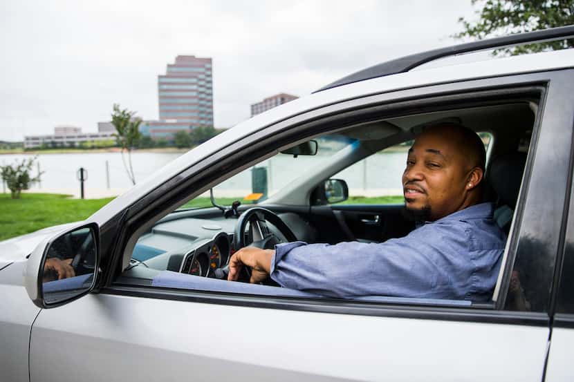 Milton Green, who owns a small courier business, poses for a photo in his vehicle on Monday,...