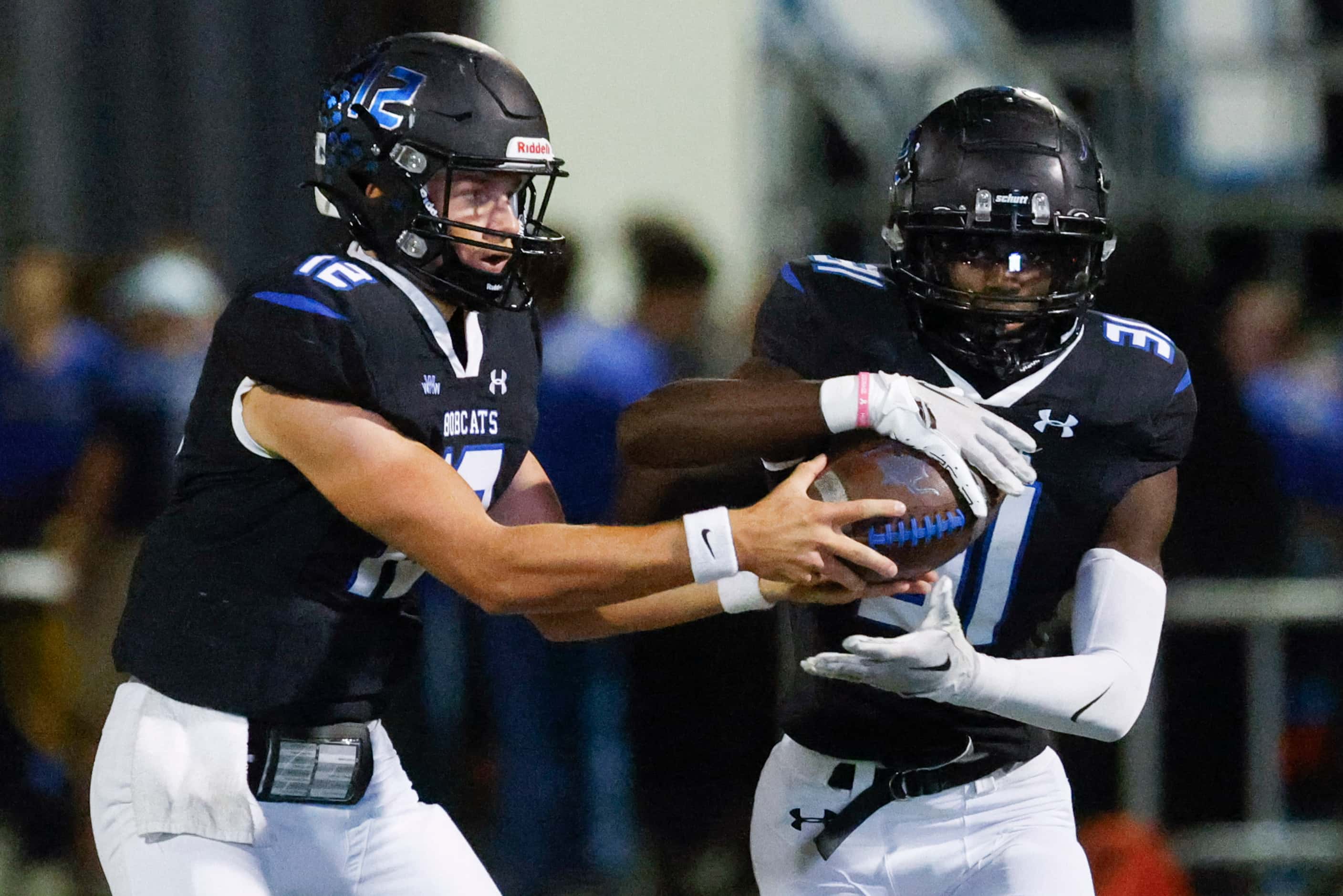 Byron Nelson’s Tom Von Grote (left) hands the ball to Manny Mulumba (31) during the first...