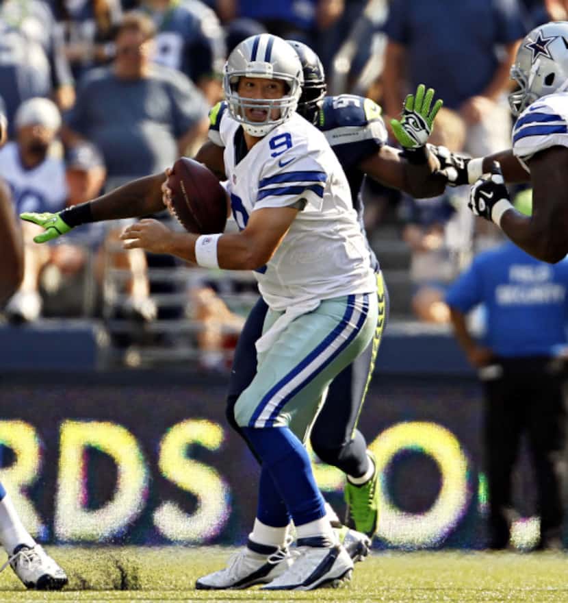 Dallas Cowboys quarterback Tony Romo struggles in the pocket during the second half of...