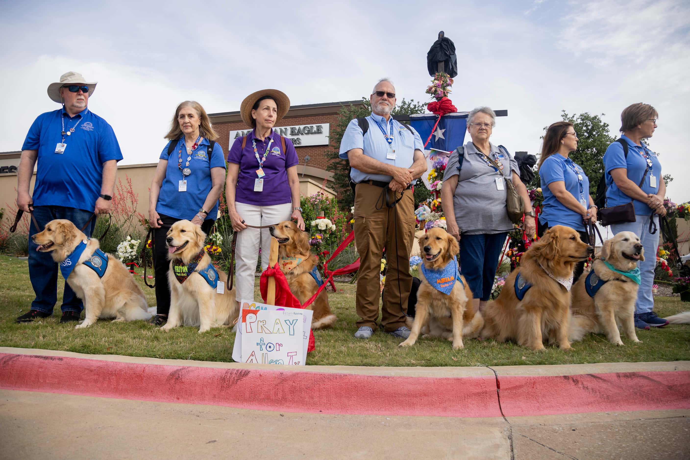 Volunteers with Lutheran Church Charities bring emotional support dogs to the memorial...