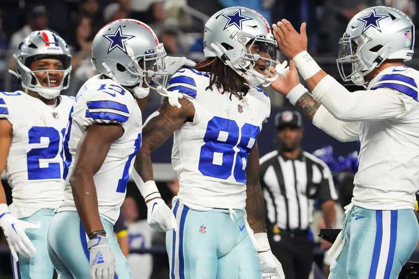 Dallas Cowboys wide receiver CeeDee Lamb (88) celebrates with quarterback Dak Prescott (4),...