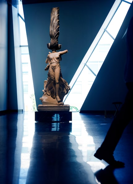 Artist Xu Zhen's standing figure at the top of the Crow Museum's grand staircase..