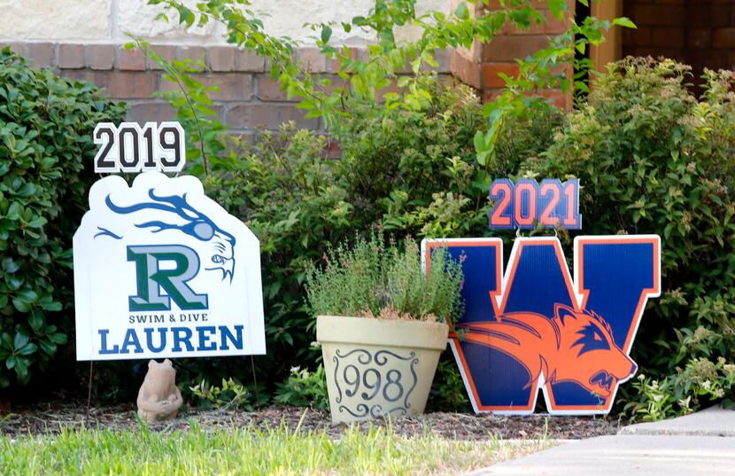 Yard signs at a home on Golden Camp Rd. in Frisco displays divided loyalties to high school...