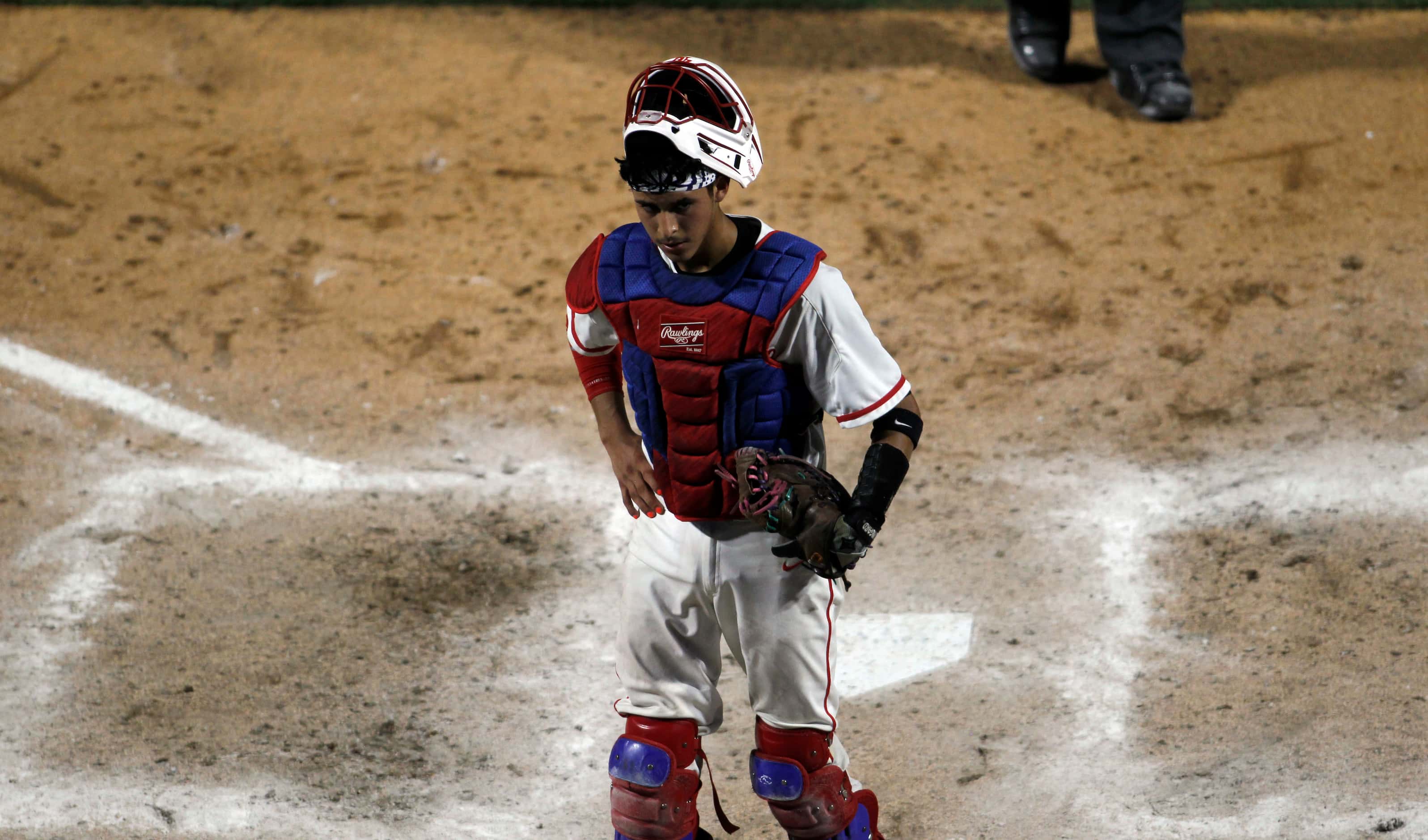 Grapevine catcher Gianni Corral (24) pauses after two throwing errors on the same play...