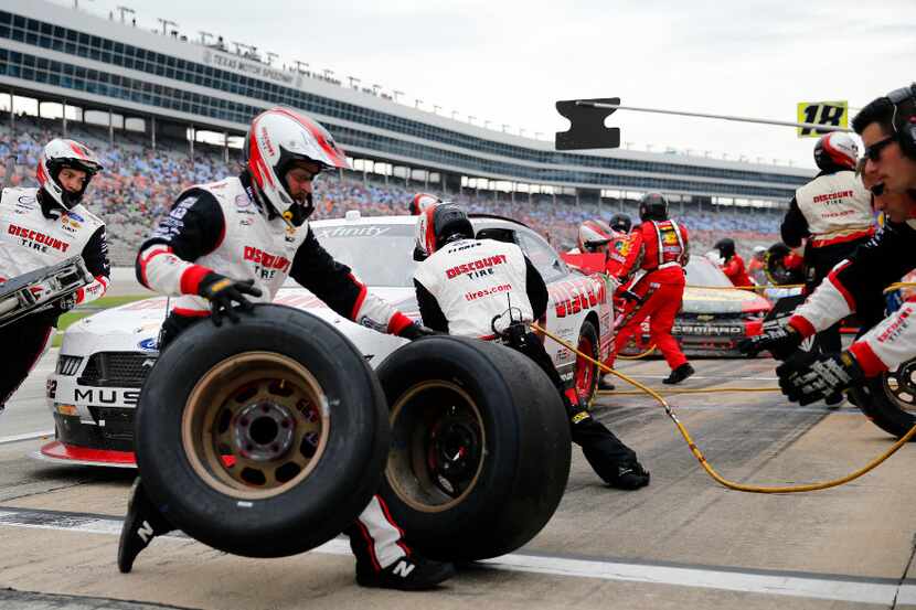 Crewman for Xfinity Series Brad Keselowski (22) race around the car during a four-tire...