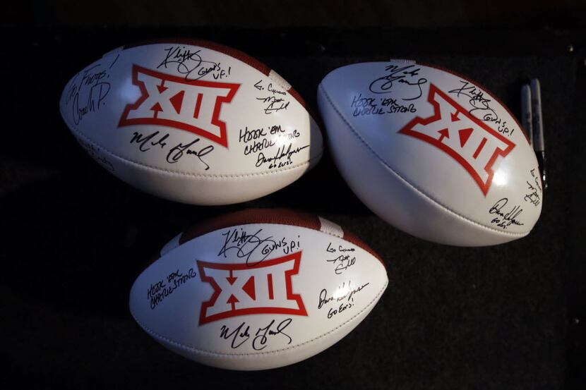 Conference footballs were signed by it's head football coaches during the Big 12 Conference...