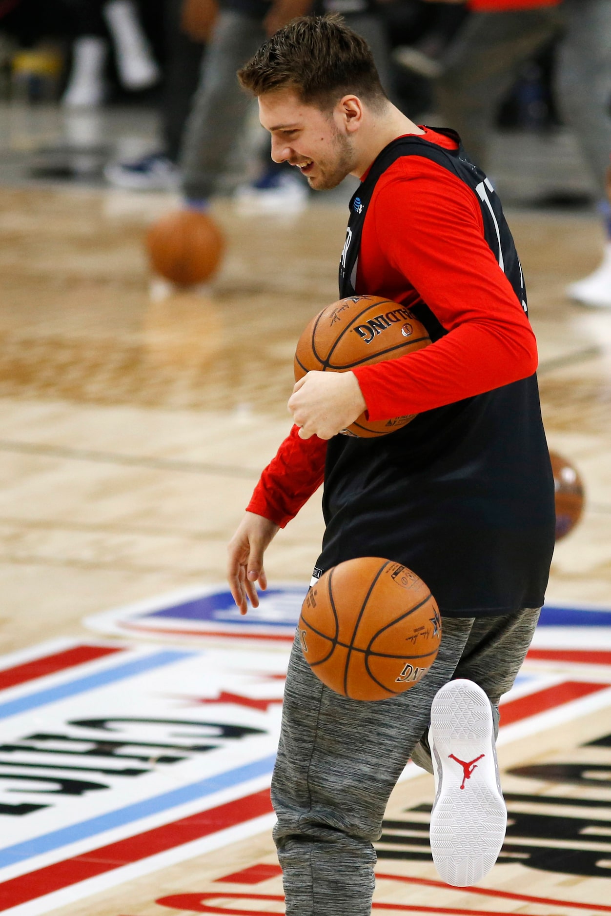 Team Lebron's Dallas Mavericks forward Luka Doncic (77) playfully kicks a ball during...