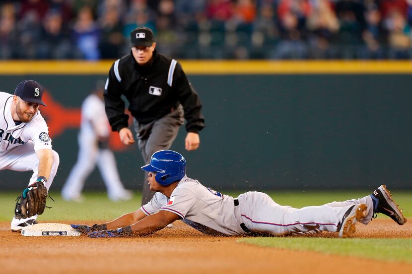 Adrian Beltre of the Texas Rangers dives into second with a double against second baseman...
